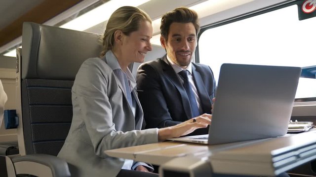 two colleagues working on a train