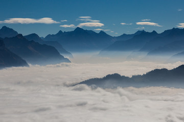 sea of fog over Schwyz and Uri in Swiss mountains with blue sky - obrazy, fototapety, plakaty