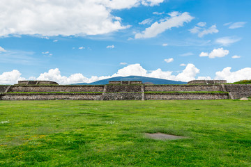 Fototapeta na wymiar Ruins of the architecturally significant Mesoamerican pyramids and green grassland located at at Teotihuacan, an ancient Mesoamerican city located in a sub-valley of the Valley of Mexico