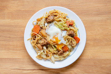 Pork Curry spaghetti  on wooden background ( Onsen tamago, Potato, enoki mushroom, onion, broccoli, Japanese style,)