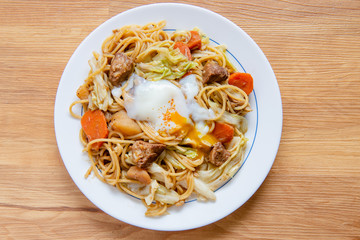 Pork Curry spaghetti  on wooden background ( Onsen tamago, Potato, enoki mushroom, onion, broccoli, Japanese style,)