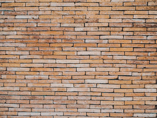 The background of the brick wall in light orange tone . Old red brick wall vintage texture. Grunge stonewall background for text or image.Brick wall of Orange yellow.