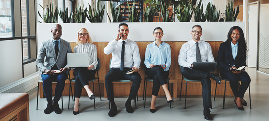 Smiling businesspeople sitting together in an office reception
