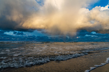 Big clouds over Baltic sea in autumn morning.