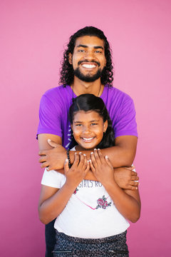 Portrait of an Afrolatinx young man and girl sibling in studio environment