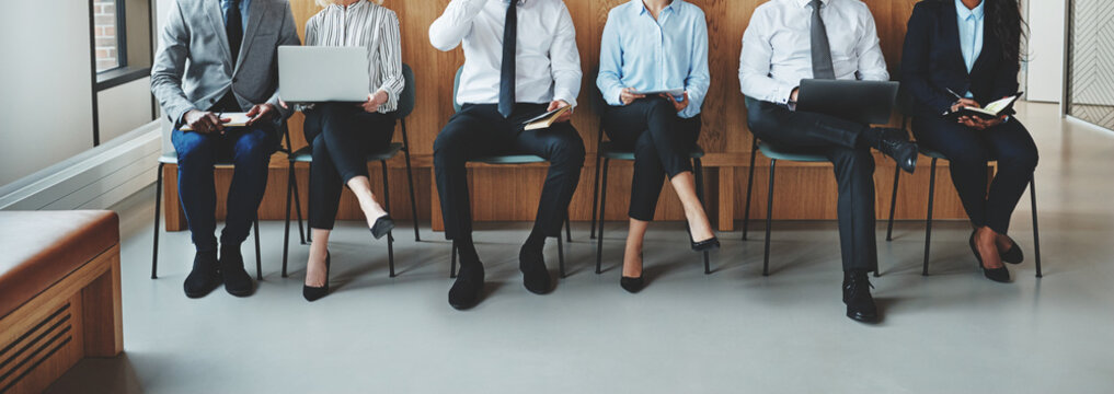 Unrecognizable businesspeople waiting for a meeting in an office
