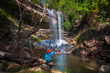 The girl in blue  sweater touring on Yung Thong waterfall, Beautiful waterfall in Udonthani province, ThaiLand.