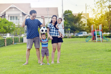 Portrait of Asian family playing together in garden
