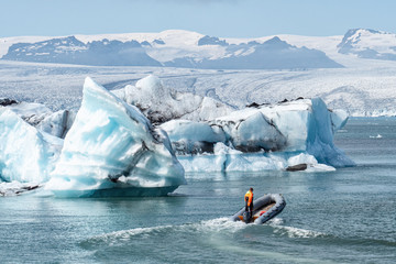 Naklejka premium The beautiful cold winter landscape of the Jokulsarlon glacier lagoon, Iceland, in the winter with snow-capped mountain as a background.