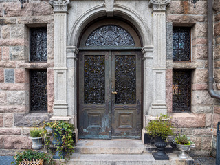 Fototapeta na wymiar Metallic entrance door to the vintage building