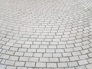 Cobblestones piled in radial rows.