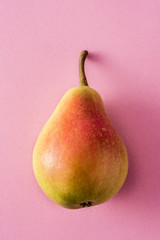 Healthy fresh pear on pink background