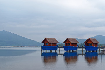 Fototapeta na wymiar Romantic boat sheds on the shore in the lagoon of Lang Co, Vietnam
