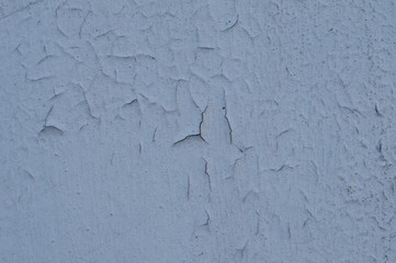 Cracked Broken Destroyed Weathered Plaster Paint on the Exterior White Wall