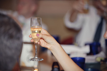 person holding champagne glass during toast