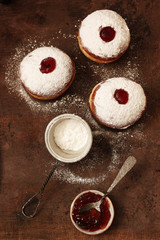 Tasty donuts with jam on wooden background - Hanukkah celebration concept .