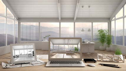 Architect designer desktop concept, laptop and tablet on wooden desk with screen showing interior design project and CAD sketch, blurred draft in the background, modern white kitchen