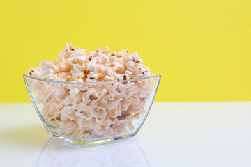popcorn in a glass bowl with copy space