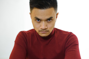 Fototapeta premium Portrait of a young asian guy on a white background. Studio shot