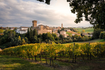 Fototapeta na wymiar Levizzano Rangone Castle, with vineyards, during autumn. Modena province, Emilia Romagna, Italy