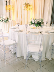 Table settings for a luxury wedding reception. Outdoor wedding