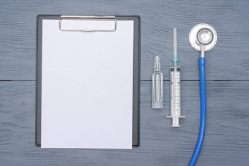 Fototapeta na wymiar Medical test mock up, syringe, ampule and a stethoscope.