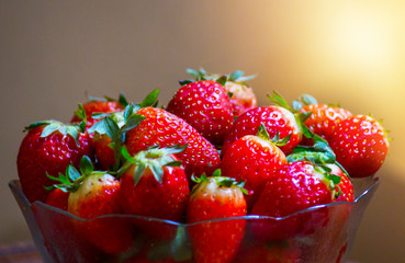 Strawberries in a glass bowl, forming a small pyramid for snack