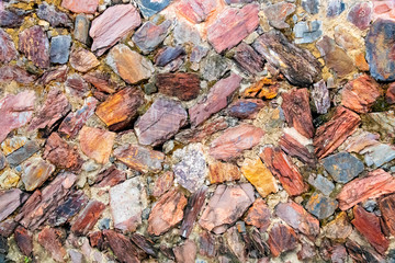 Old ancient stone wall in the sunlight in the daytime,suitable to use as a background, idea copy space.