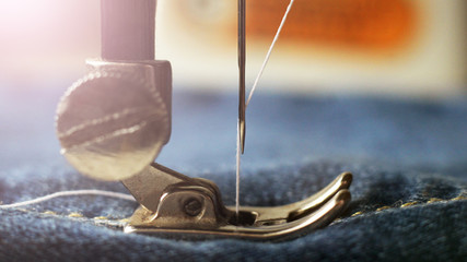 Sewing machine, white thread in needle, industrial object