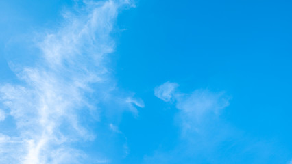 Blue sky background with tiny clouds