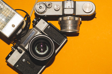 Analog cameras on yellow background. copy space