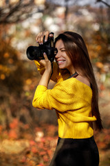 woman photographer takes pictures in nature, the photographer in action