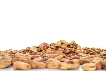 Lot of whole fresh brown bean vicia faba isolated on white background