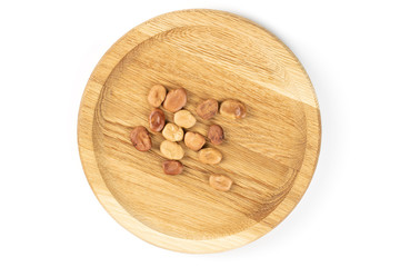 Lot of whole fresh brown bean vicia faba on bamboo plate flatlay isolated on white background