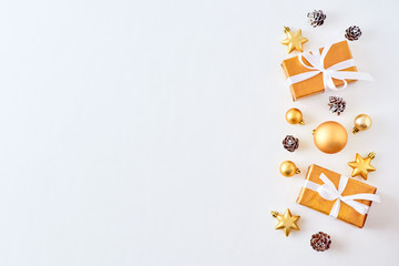 Flat lay christmas border with gold christmas balls and gift box on a white background