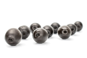 Lot of whole canned black olive isolated on white background