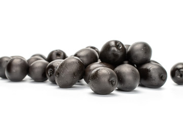 Lot of whole canned black olive isolated on white background