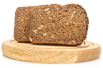 Group of two slices of fresh baked dark bread on bamboo plate isolated on white background