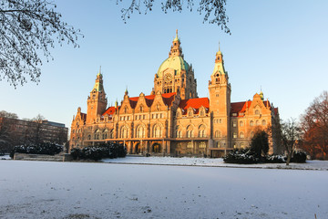 Panorama of the New town hall Rathaus and masch park in winter sunset in Hannover. There is frozen lake.