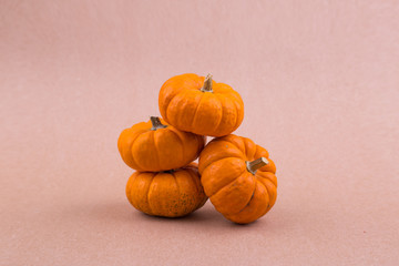 Four mini pumpkins for Halloween on the paper. Decor.