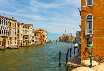 Grand Canal in Venice with boats and gandules docket motor boat near the bridge.