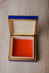 closed antique wooden blue jewelry box on the table