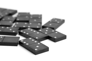 Dominoes top view. Black domino figures. Domino chips close up. Scattered black dominoes.