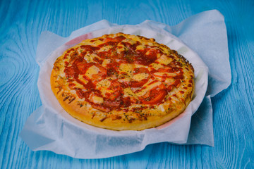 Homemade pepperoni pizza on the table. Tomato, cheese and ham main ingredients