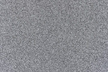 Fototapeta premium A smooth light grey asphalt pavement texture with small rocks