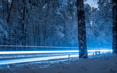 Freeze light, Time-lapse, Headlights of cars at night on a snowy road in winter.