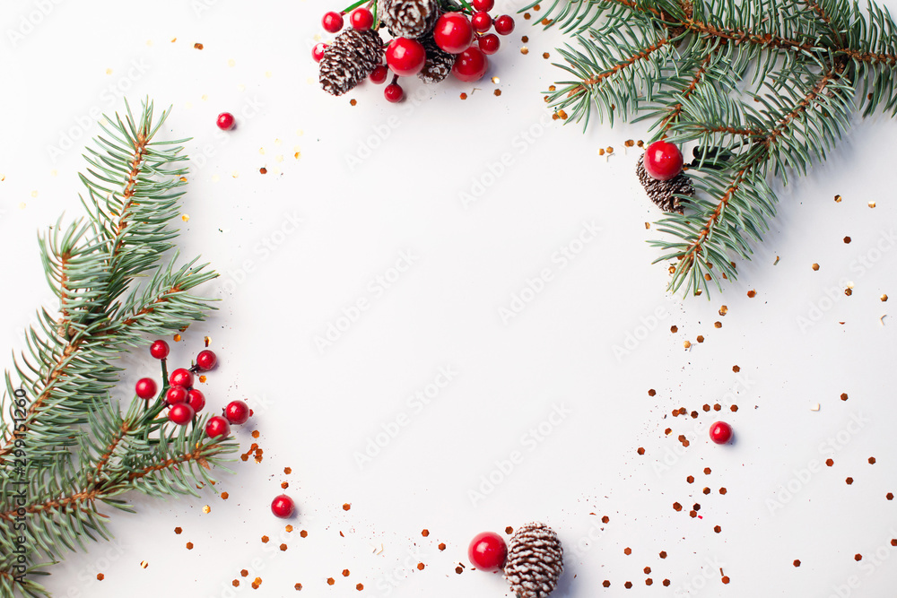 Wall mural christmas composition flatlay. spruce branches, red berries on white background with space for text