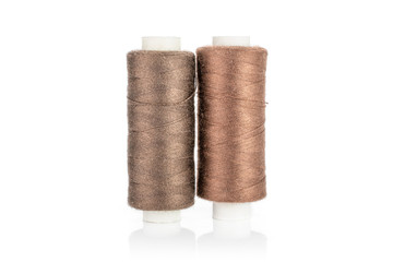 Group of two whole haberdashery item standing thread spools isolated on white background