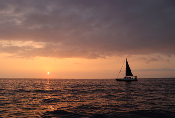 Sailing ship at sunset on the sea