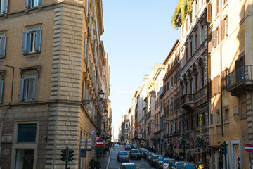Fototapeta na wymiar Italy, Rome - December 10, 2018. Street of Rome, italian buildings people and cars at sunny day. Daily life of Rome